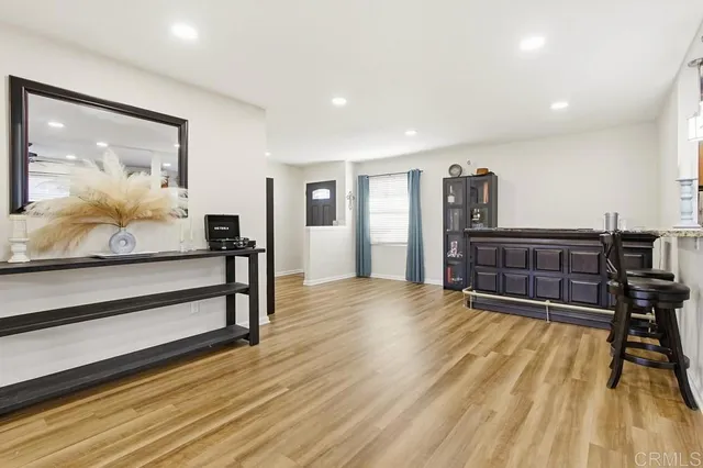 a view of a room with furniture and wooden floor