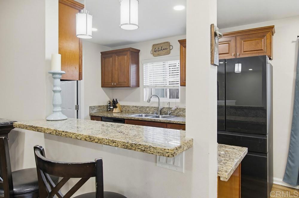 8838 Innsdale Avenue Spring Valley, CA 91977 - Photo 10 of 38 a bathroom with a granite countertop sink and a mirror