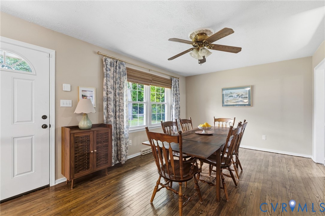 Elegant dining room showcasing rich wood-finish fl