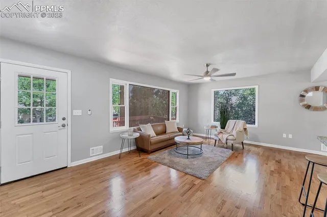 a living room with furniture and wooden floor