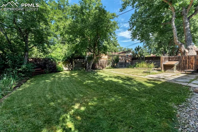 a view of a house with backyard and sitting area
