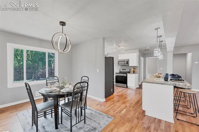 a view of a dining room with furniture window and wooden floor