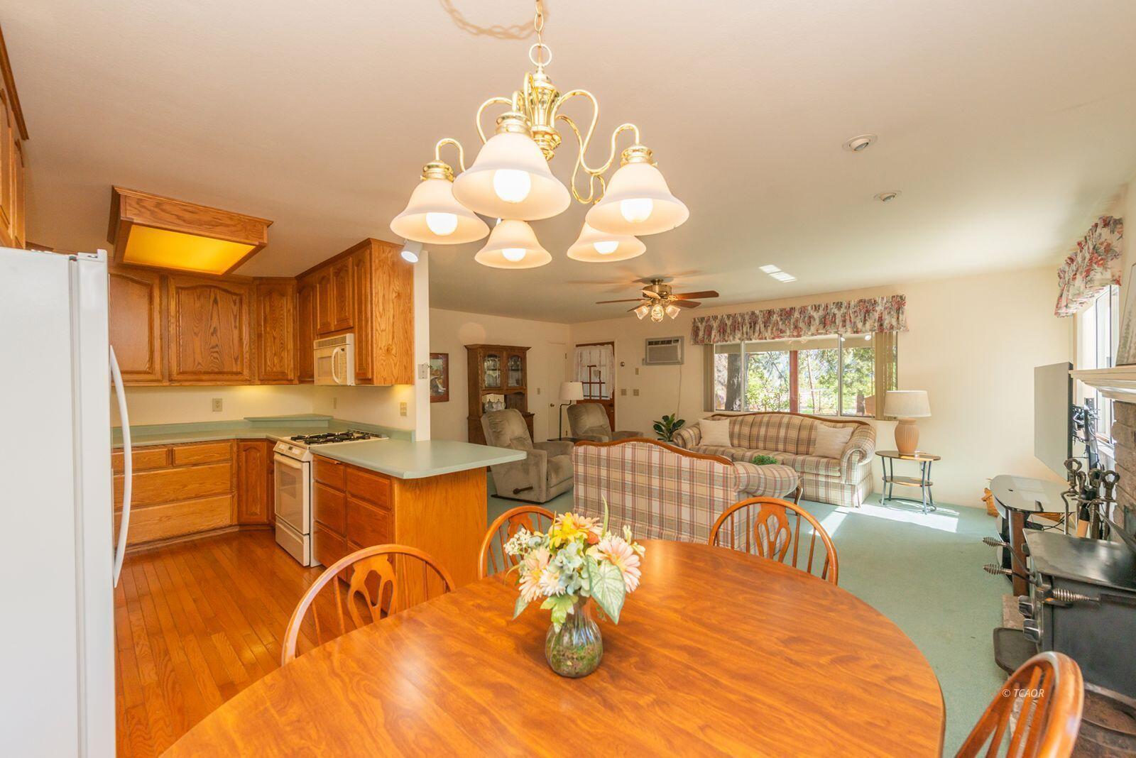 220-230 Lakeview Drive Trinity Center, CA 96091 - Photo 12 of 48 a view of a dining room with furniture a kitchen and chandelier
