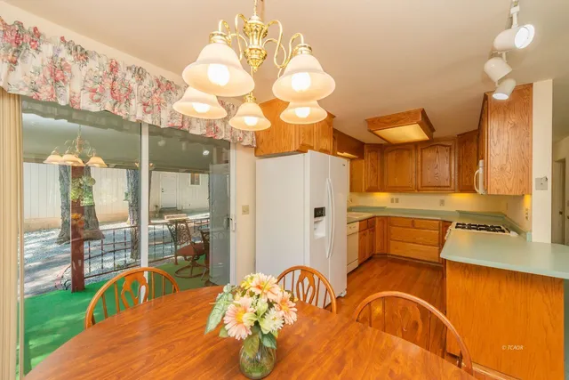 a bedroom with a bed and chandelier