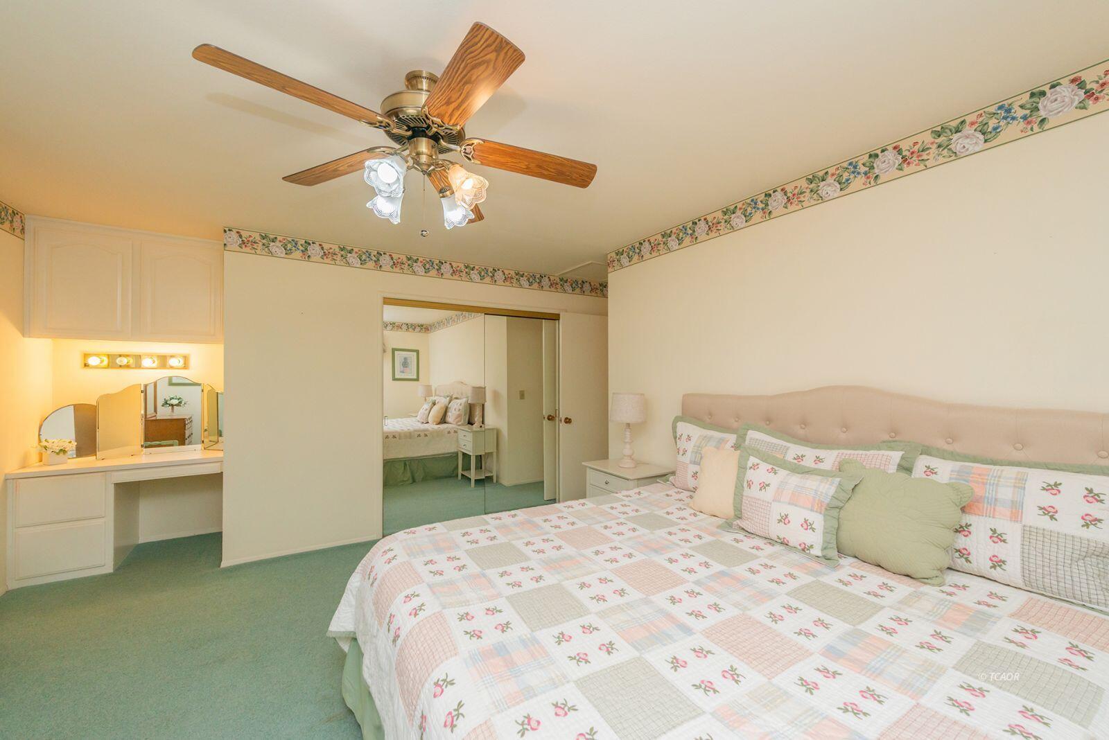 220-230 Lakeview Drive Trinity Center, CA 96091 - Photo 24 of 48 a bedroom with a large bed and a chandelier