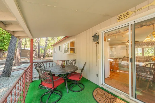 a balcony with table and chairs