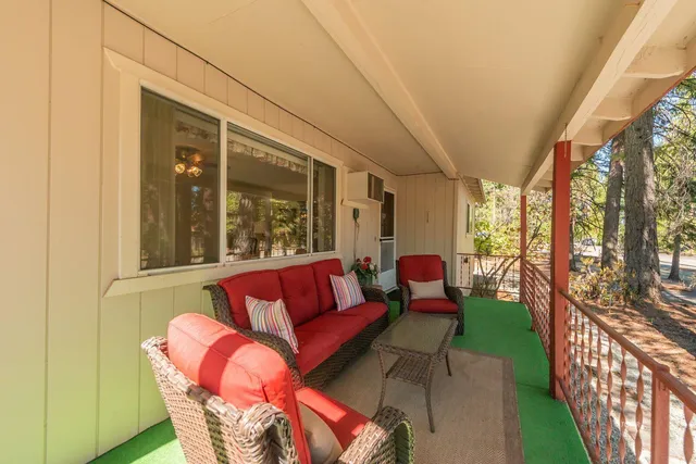 a outdoor living space with patio furniture and wooden floor