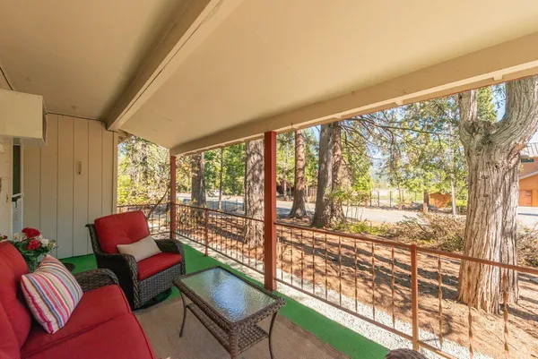 a living room with furniture and a floor to ceiling window