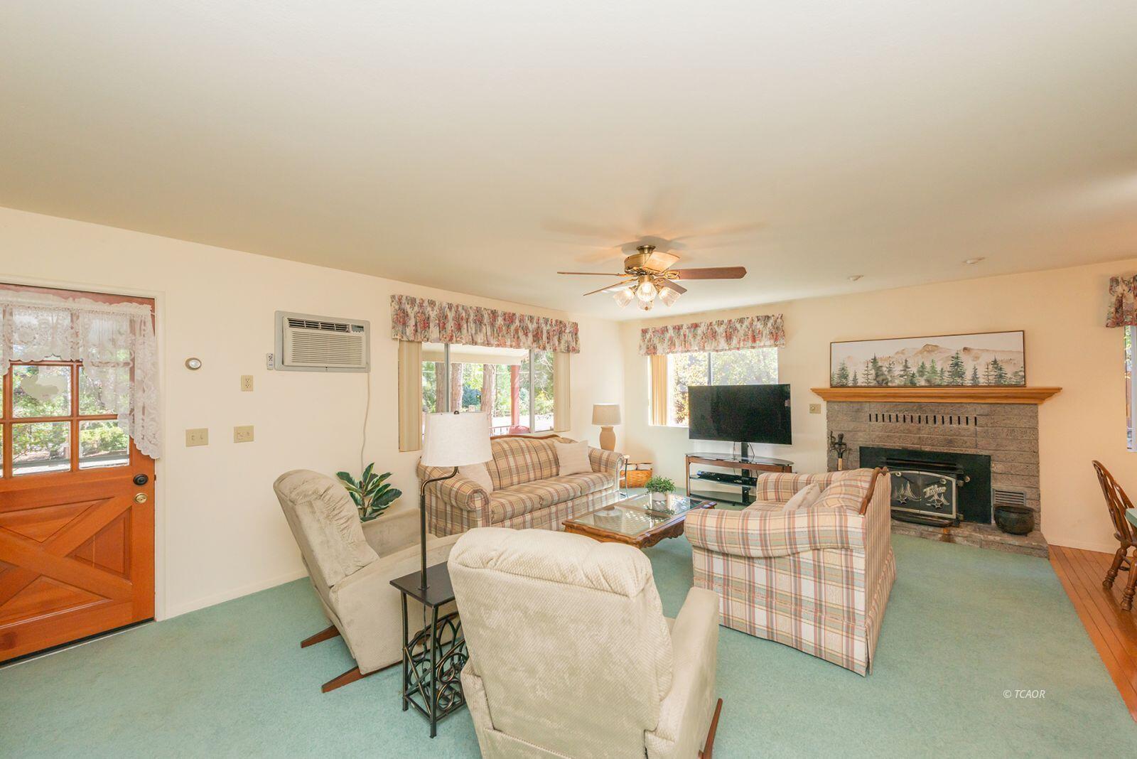 220-230 Lakeview Drive Trinity Center, CA 96091 - Photo 6 of 48 a living room with furniture a fireplace and a large window
