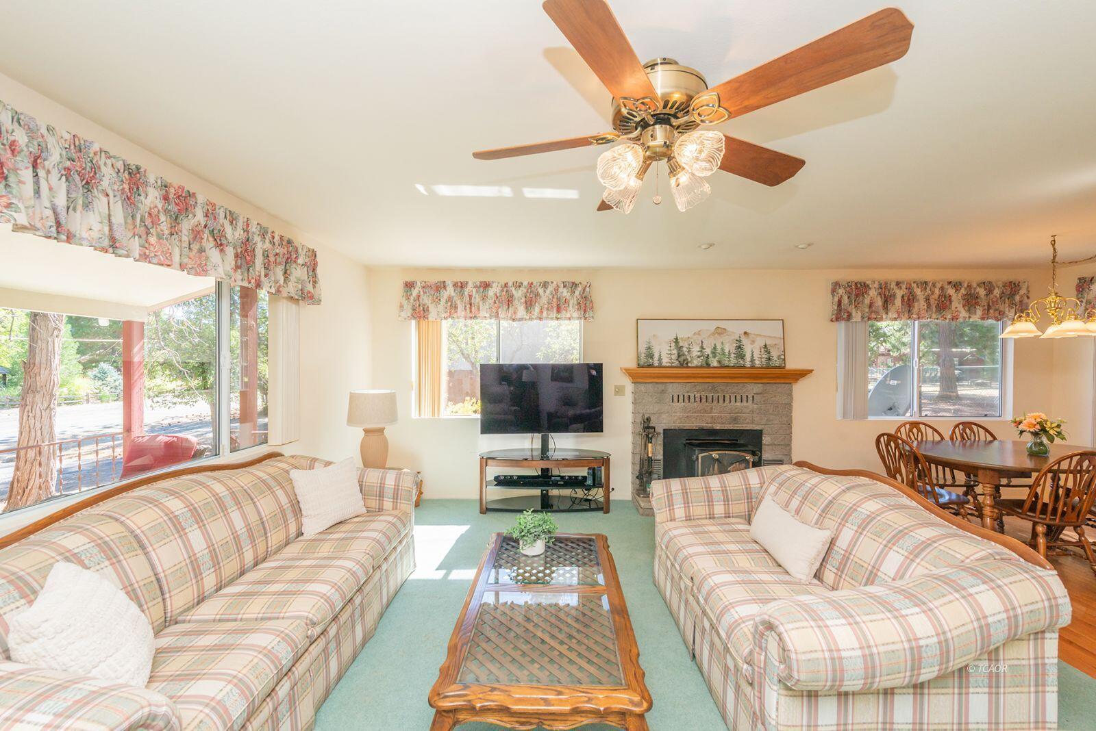 220-230 Lakeview Drive Trinity Center, CA 96091 - Photo 7 of 48 a living room with furniture a fireplace and a large window