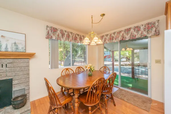 a dining room with furniture a chandelier and window