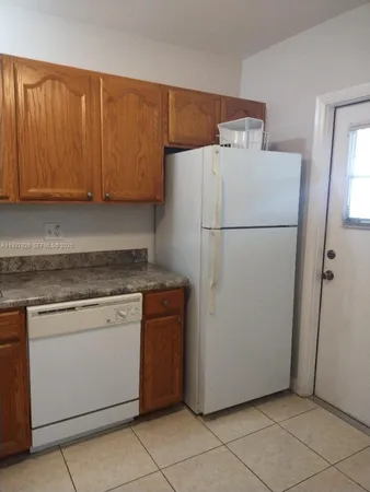 a white refrigerator freezer sitting in a kitchen