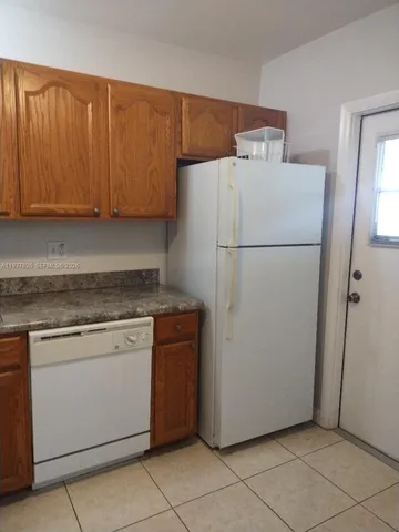 a white refrigerator freezer sitting in a kitchen