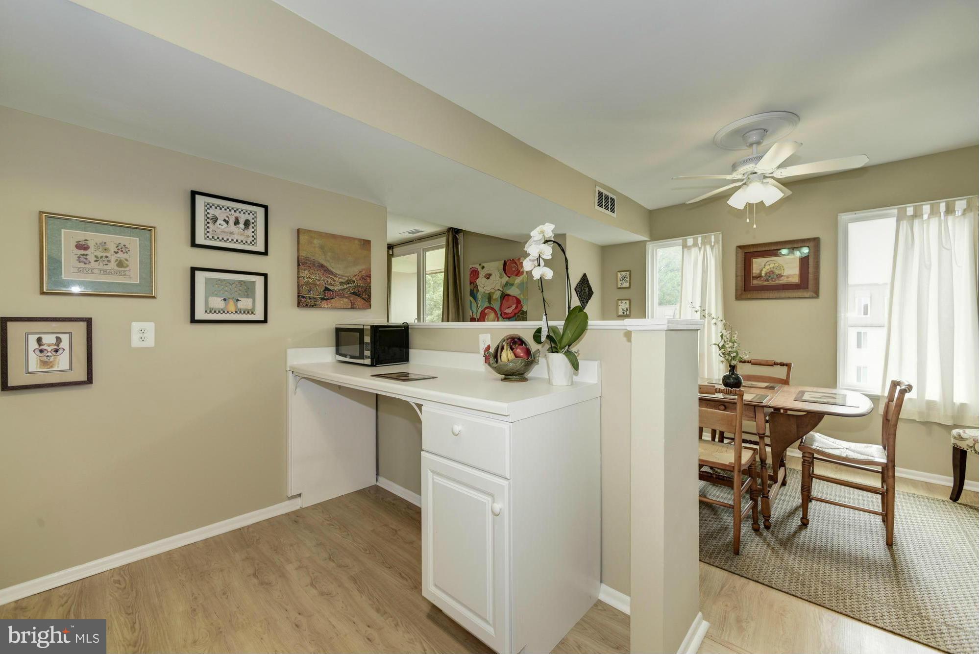 5001 7th Road South, Unit 302 Arlington, VA 22204 - Photo 10 of 30 a view of kitchen island with furniture wooden floor and dining table