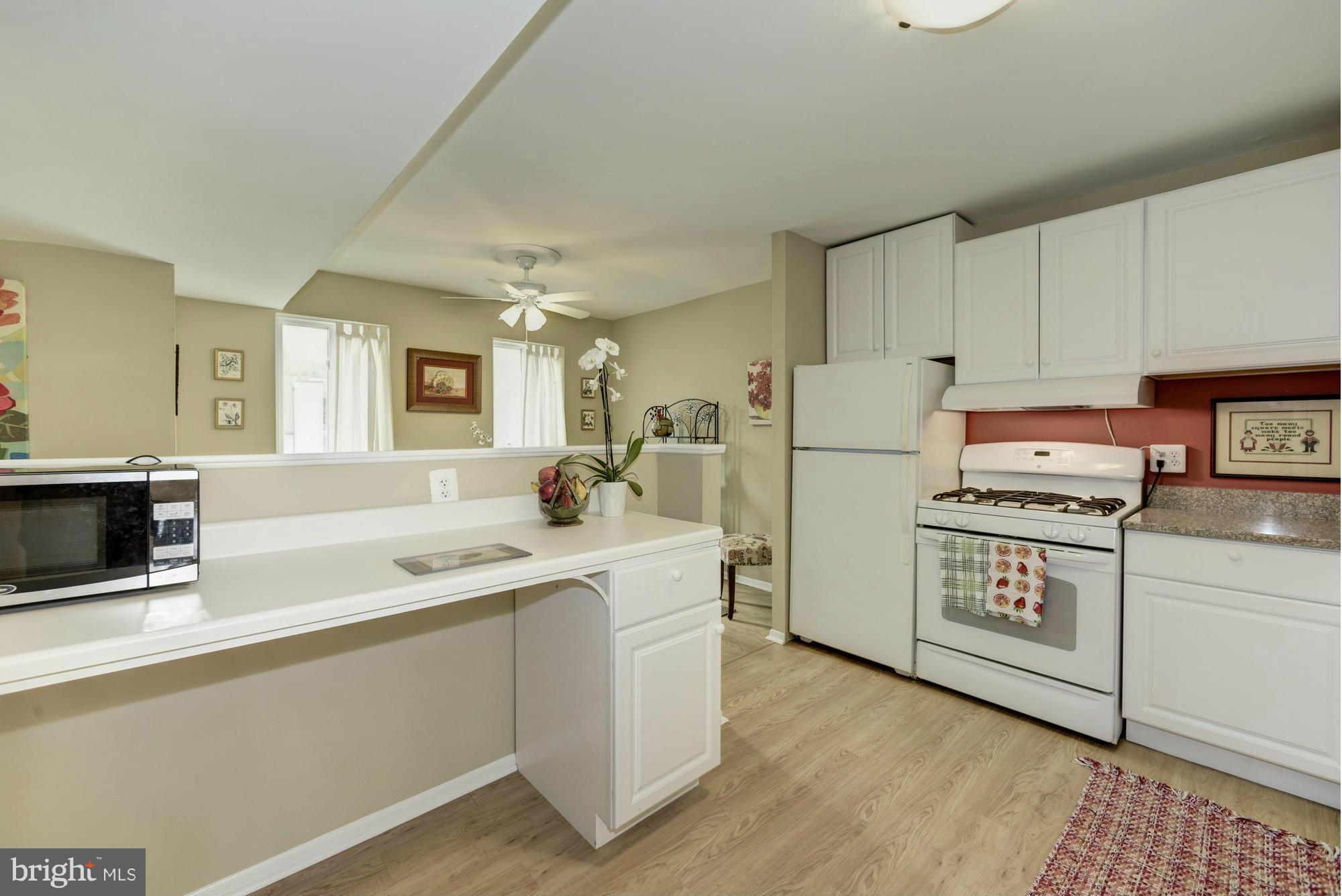 5001 7th Road South, Unit 302 Arlington, VA 22204 - Photo 11 of 30 a kitchen with stainless steel appliances granite countertop a refrigerator a stove a sink and a microwave