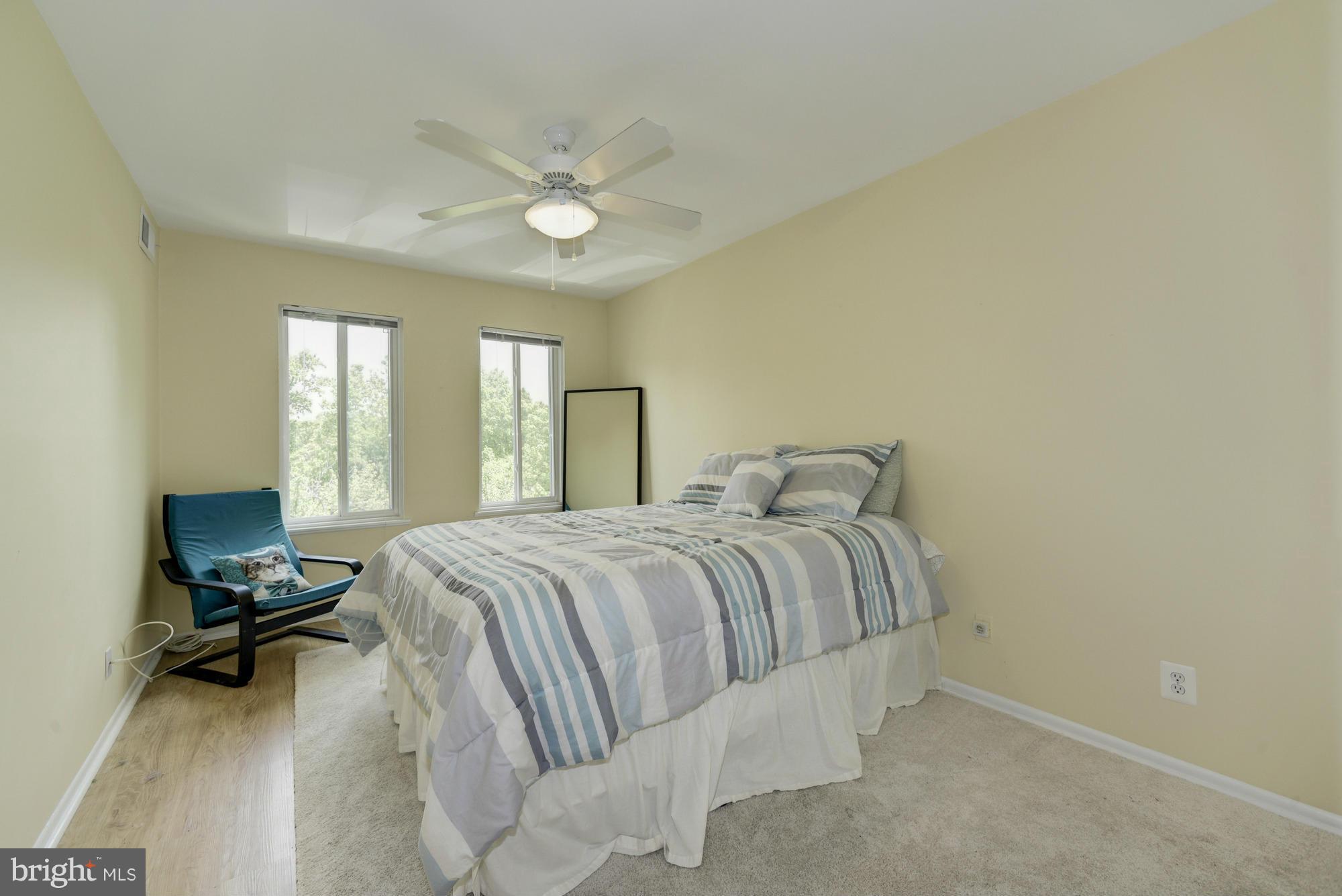 5001 7th Road South, Unit 302 Arlington, VA 22204 - Photo 17 of 30 a bedroom with a bed and a chandelier