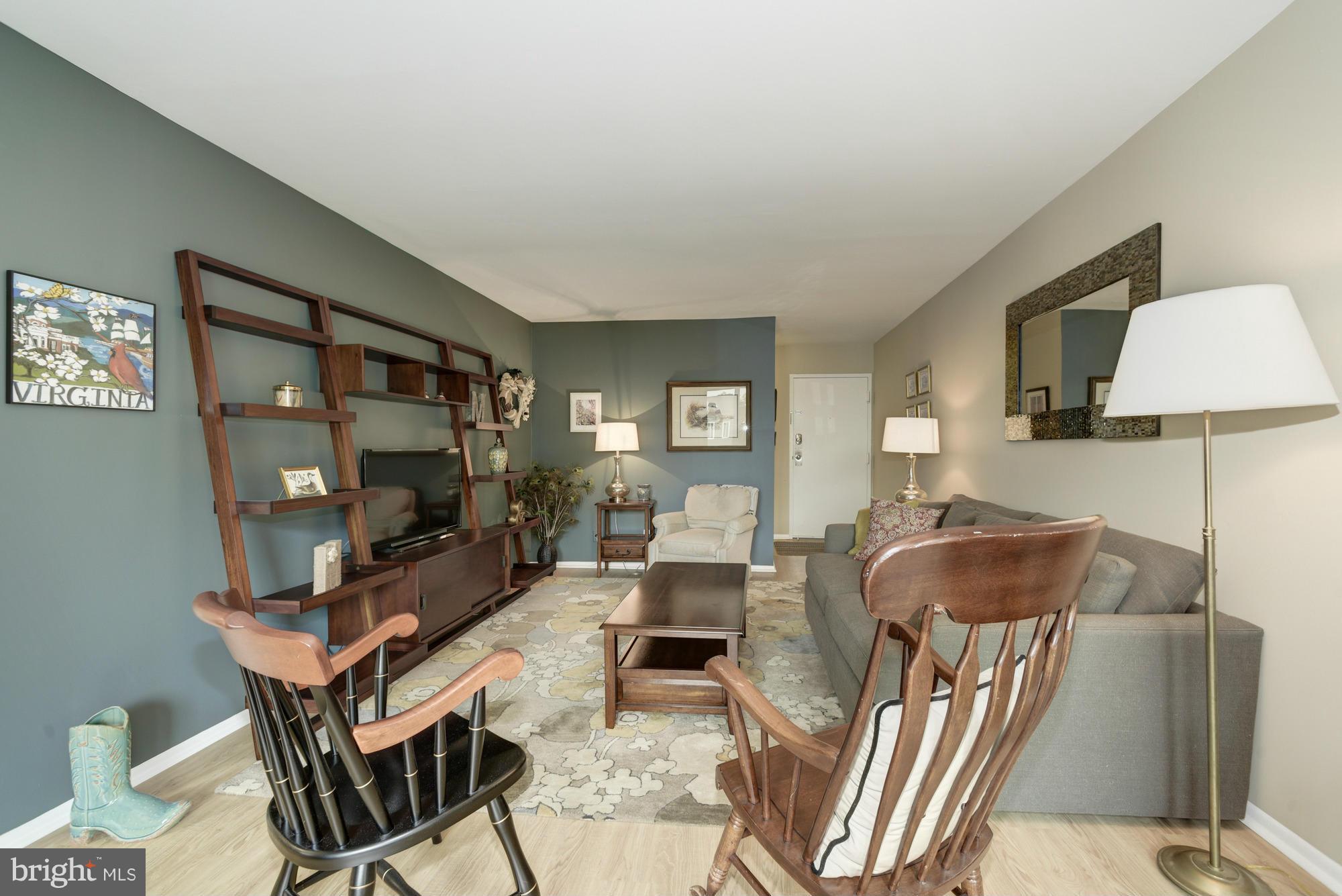 5001 7th Road South, Unit 302 Arlington, VA 22204 - Photo 6 of 30 a living room with furniture a flat screen tv and a large window
