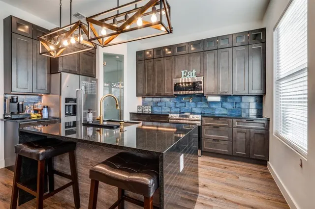 a kitchen with granite countertop a sink and wooden cabinets