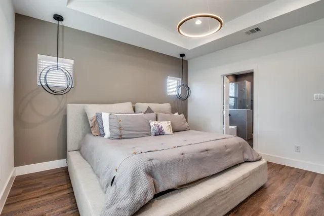 a bed room with a bed mirror and a window