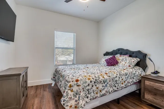 a bedroom with a bed and flat screen tv