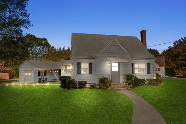 a front view of house with a garden