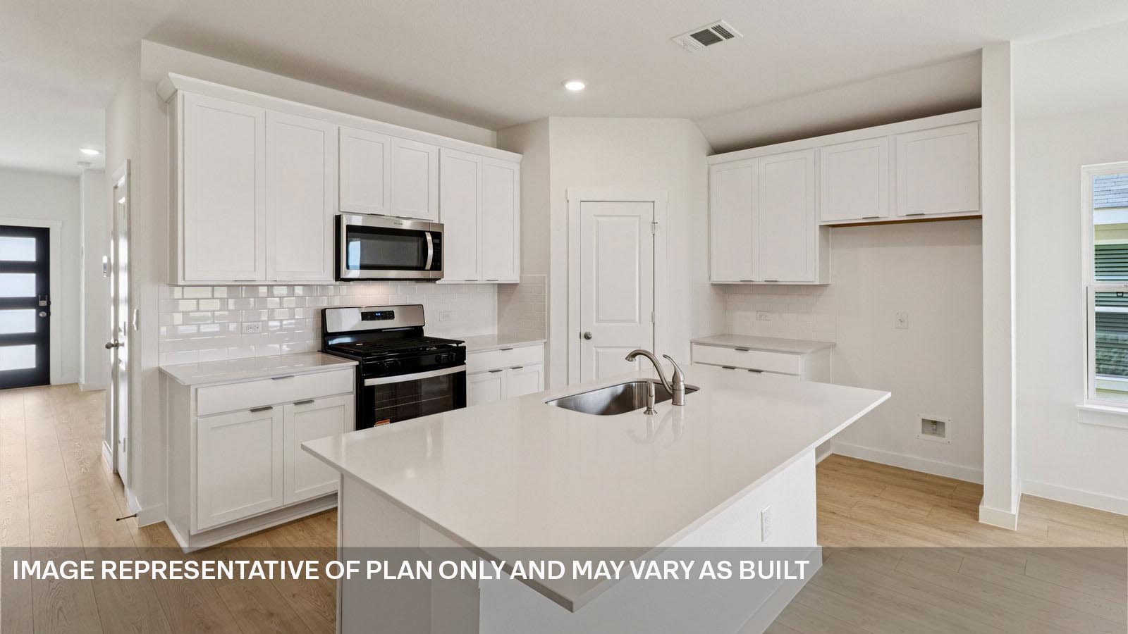 12217 Silverston Tree Bend Buda, TX 78610 - Photo 7 of 24 a kitchen with stainless steel appliances kitchen island granite countertop a sink a stove and refrigerator