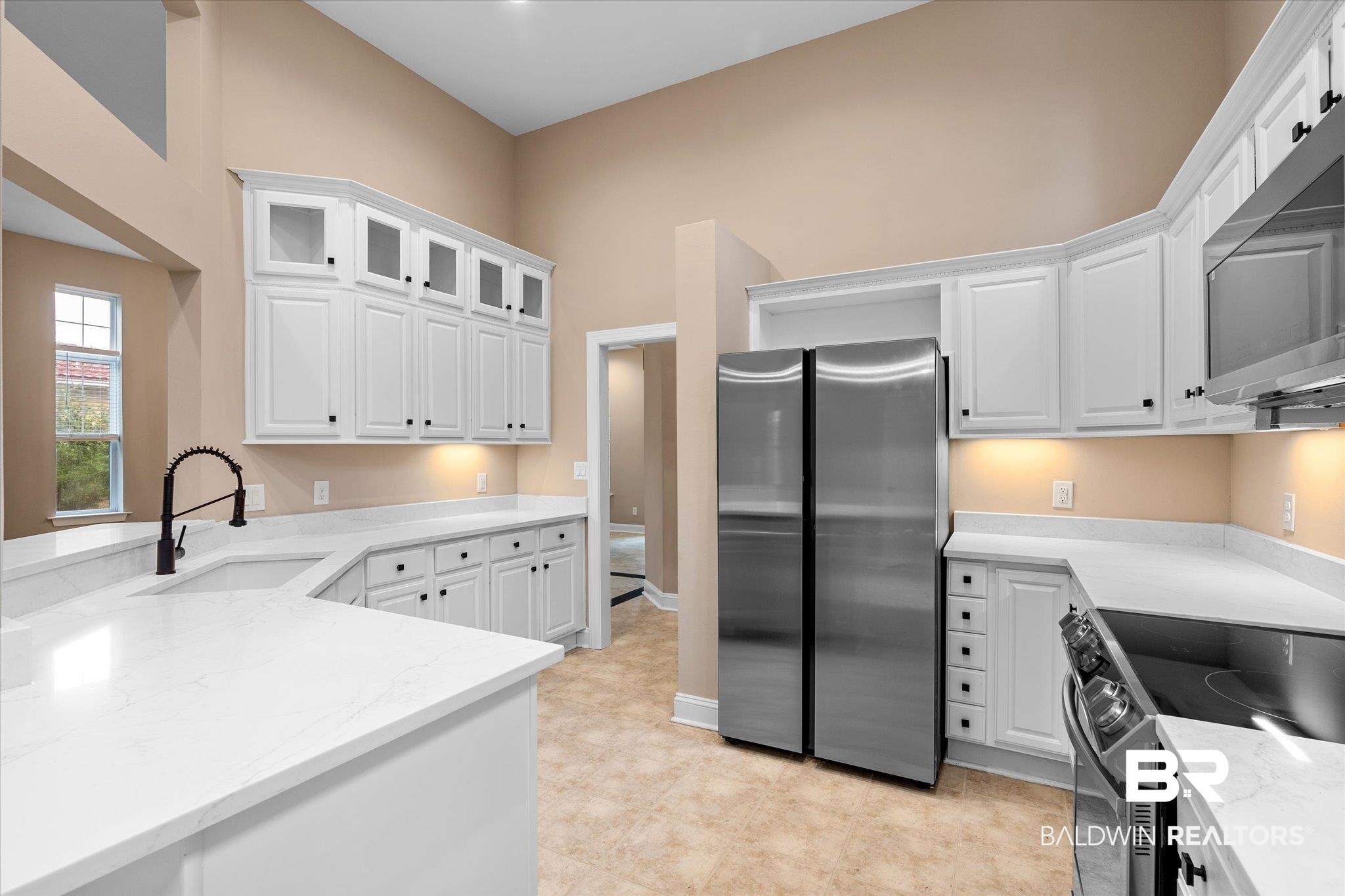 9259 Genipa Way Gulf Shores, AL 36542 - Photo 13 of 72 Kitchen with white cabinets, sink, and appliances with stainless steel finishes