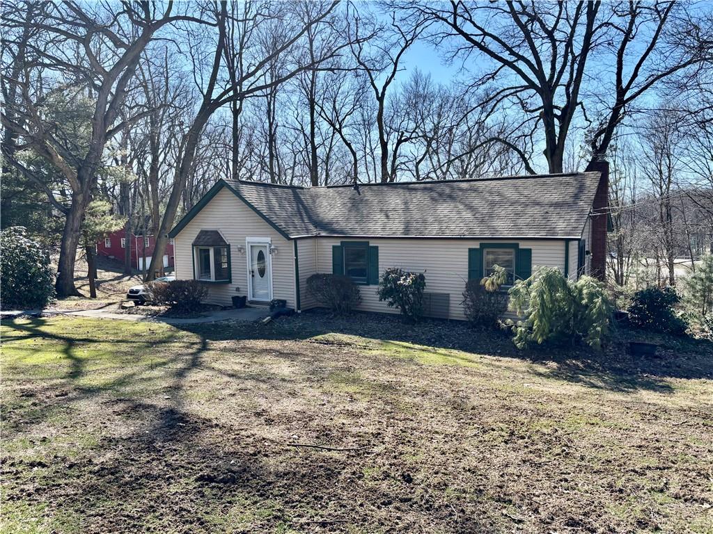 a view of a house with yard and tree s