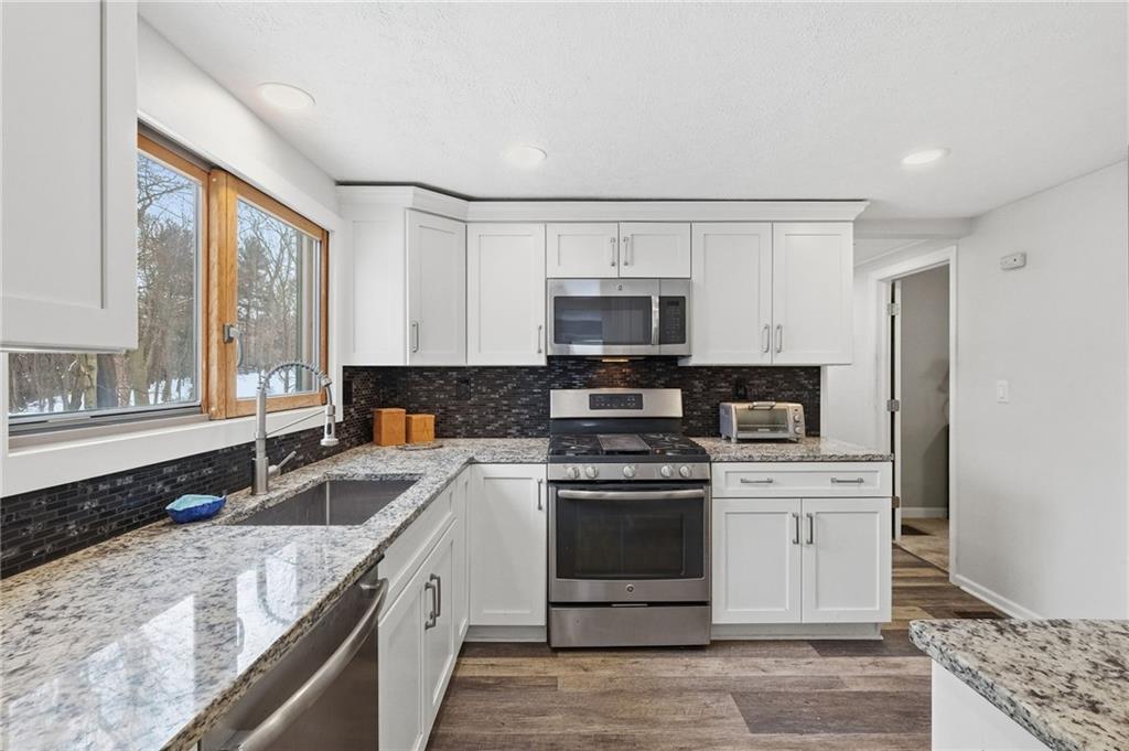 230 Neely School Road Wexford, PA 15090 - Photo 17 of 41 a kitchen with stainless steel appliances granite countertop a stove a sink and a microwave