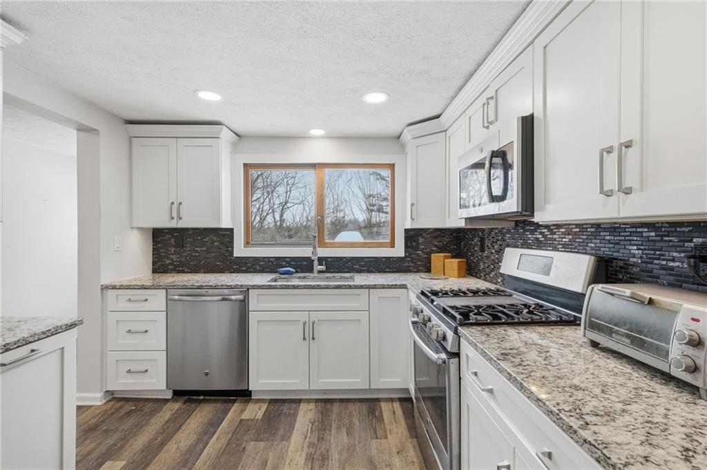 230 Neely School Road Wexford, PA 15090 - Photo 18 of 41 a kitchen with stainless steel appliances granite countertop a stove sink and cabinets
