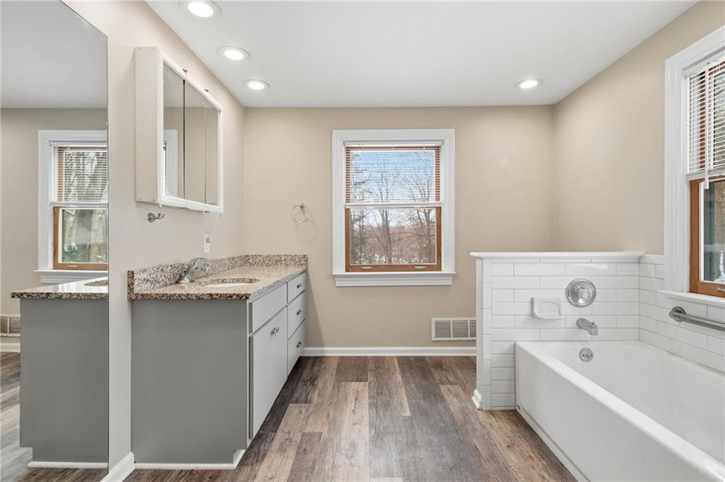 230 Neely School Road Wexford, PA 15090 - Photo 26 of 41 a bathroom with a granite countertop sink mirror bathtub and next to a window