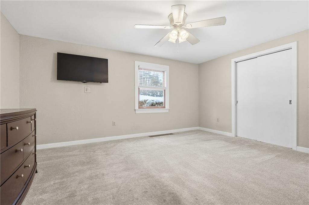 230 Neely School Road Wexford, PA 15090 - Photo 30 of 41 an empty room with windows fireplace and a ceiling fan
