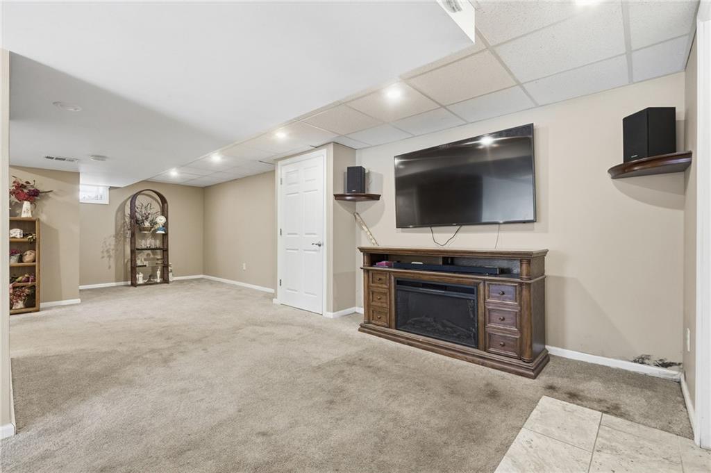 230 Neely School Road Wexford, PA 15090 - Photo 33 of 41 a living room with fireplace and a flat screen tv