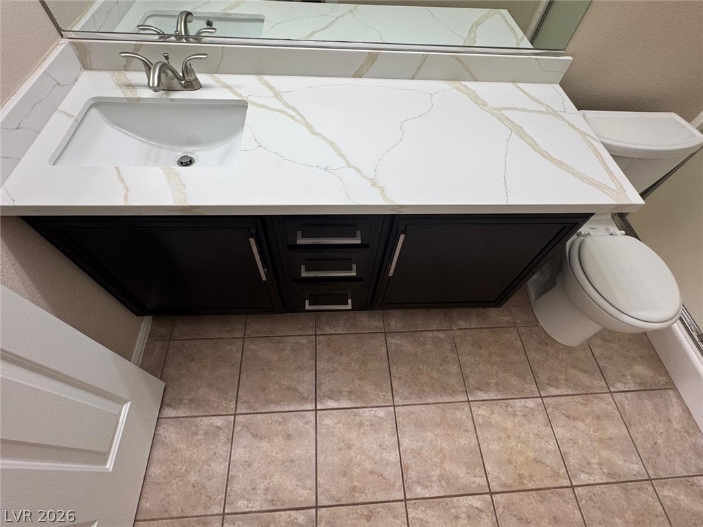 3962 Coyote Ridge Court Las Vegas, NV 89129 - Photo 32 of 35 Elegant quartz counters and a modern vanity define this well-appointed bath.