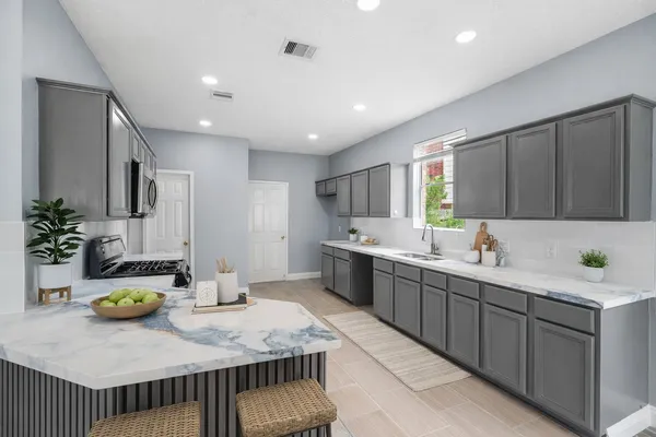 a kitchen with sink and cabinets