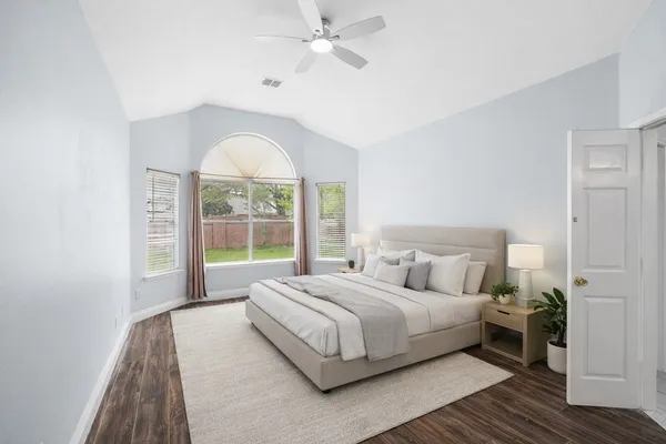 a spacious bedroom with a large bed and a large window