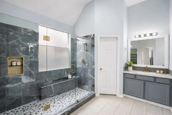 a bathroom with a double vanity sink toilet and shower