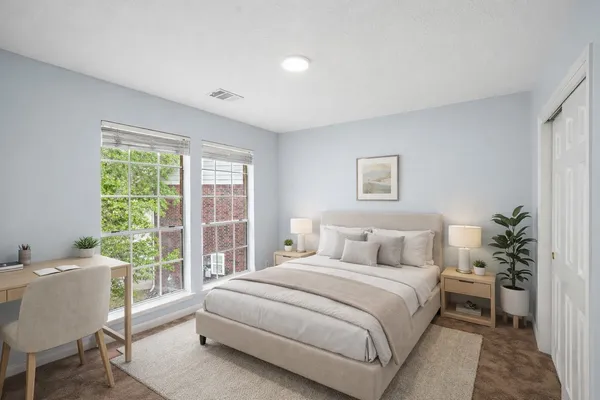 a bedroom with a large bed and a window