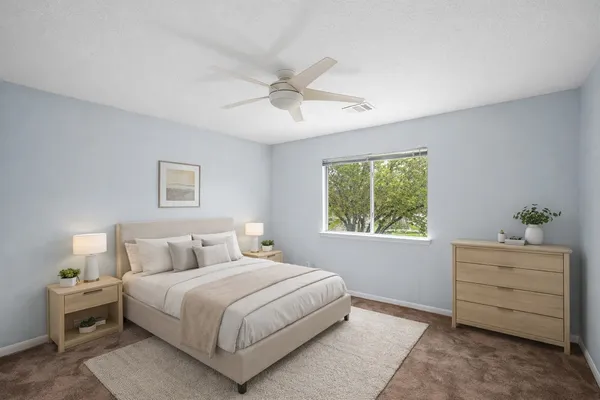 a bedroom with a bed and a window