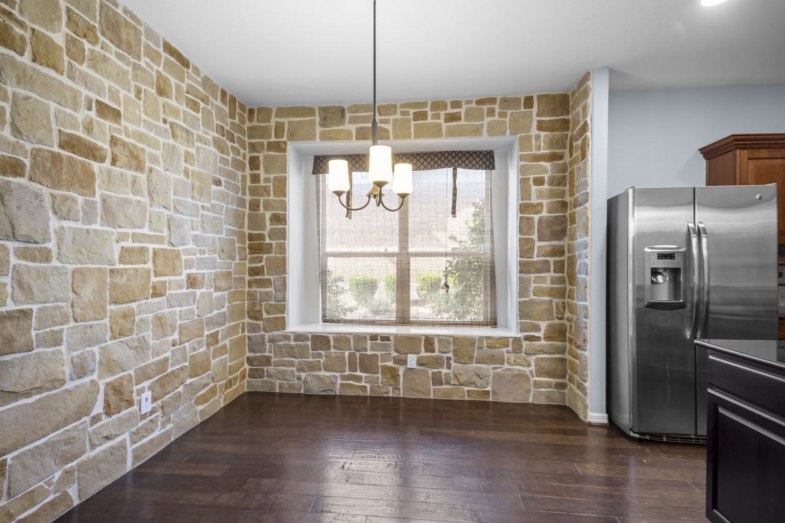245 Razzmatazz Trail Buda, TX 78610 - Photo 15 of 40 Unfurnished dining area featuring dark wood-type flooring and a chandelier