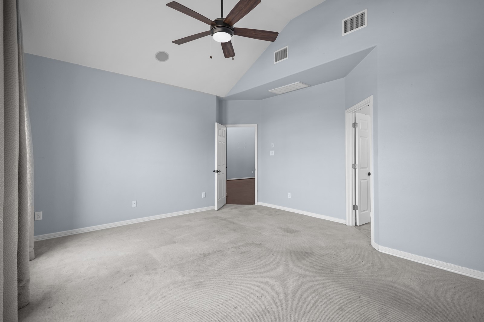 245 Razzmatazz Trail Buda, TX 78610 - Photo 20 of 40 Unfurnished bedroom featuring lofted ceiling, a ceiling fan, and light colored carpet