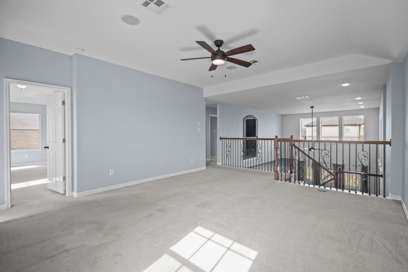 245 Razzmatazz Trail Buda, TX 78610 - Photo 26 of 40 Unfurnished room featuring a ceiling fan, light colored carpet, and recessed lighting