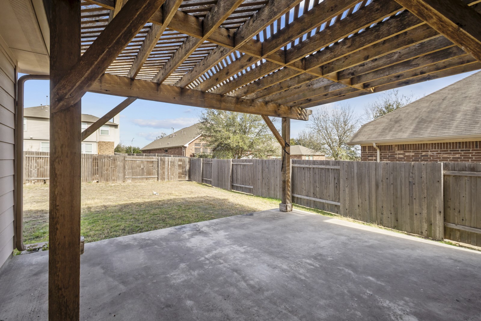 245 Razzmatazz Trail Buda, TX 78610 - Photo 36 of 40 Fenced backyard with a pergola and a patio
