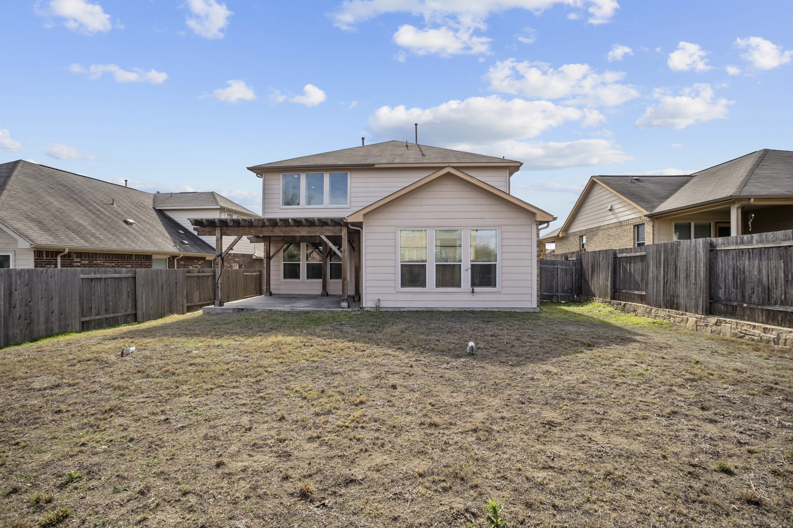245 Razzmatazz Trail Buda, TX 78610 - Photo 37 of 40 Back of house featuring a patio, a pergola, and a fenced backyard