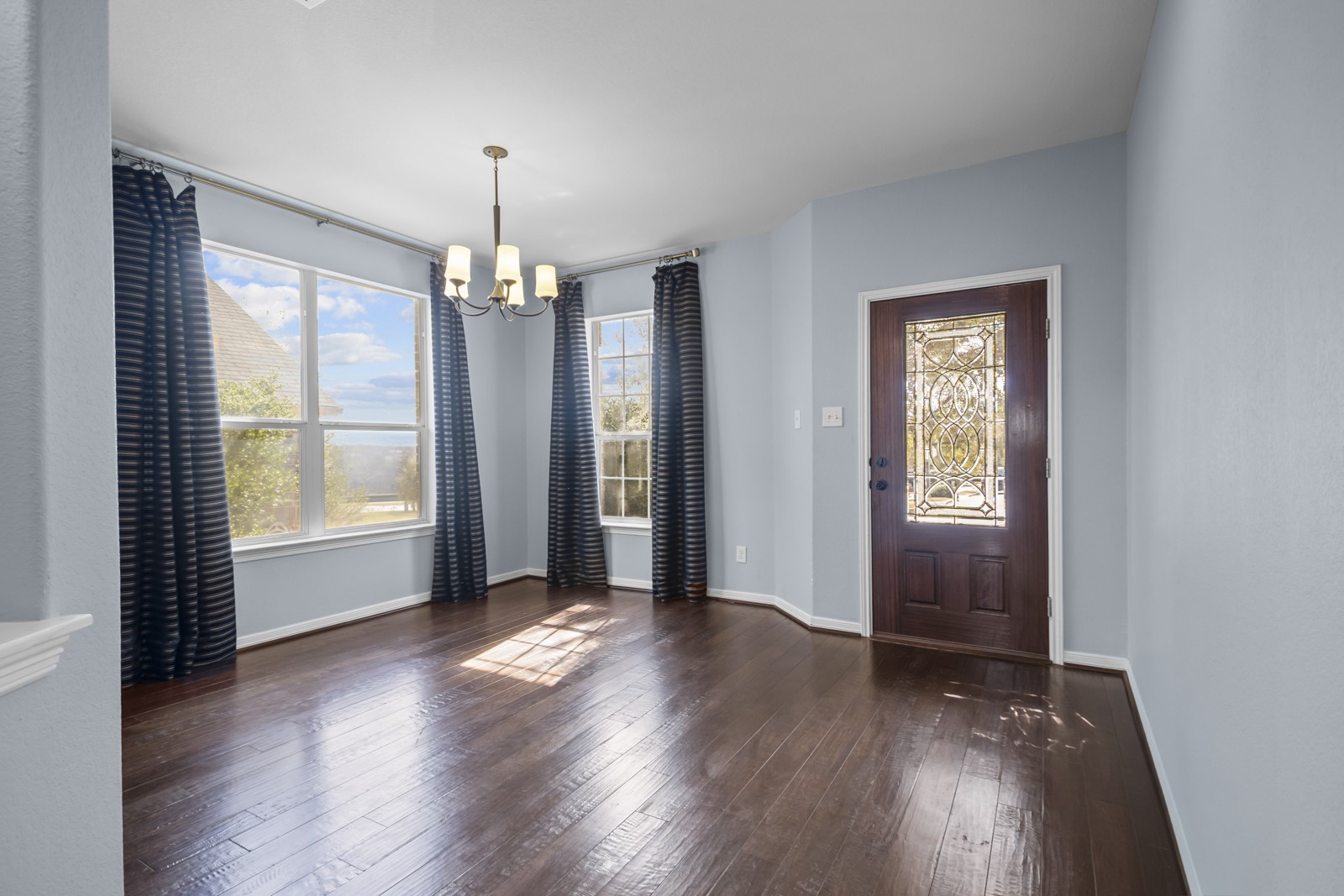 245 Razzmatazz Trail Buda, TX 78610 - Photo 5 of 40 Foyer featuring hanging lights and dark wood-style flooring