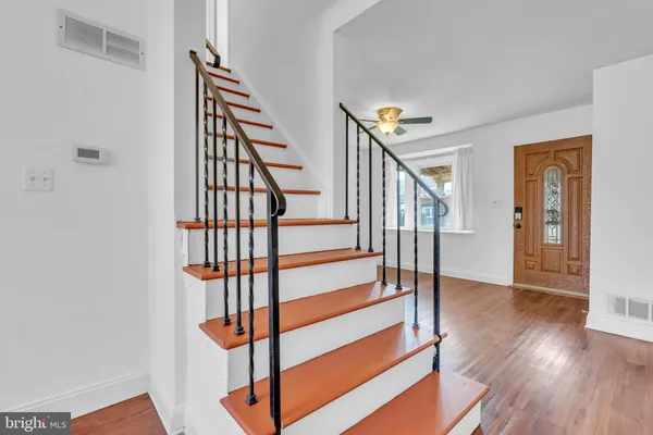 a view of entryway with wooden floor and stairs