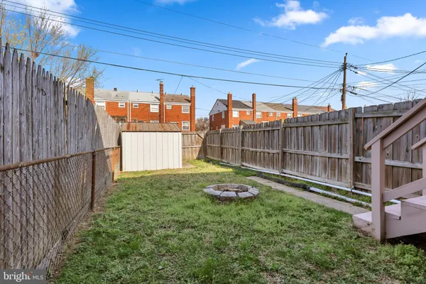 a view of a backyard with a iron fence