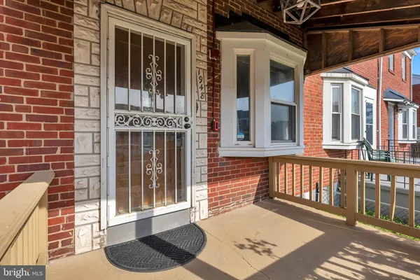 a view of a brick house with large windows