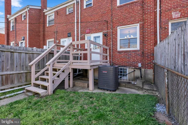 a view of a deck with a big yard and potted plants