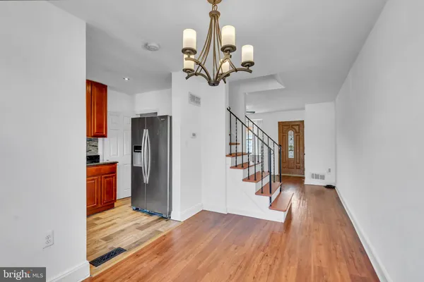 a view of entryway and hall with wooden floor